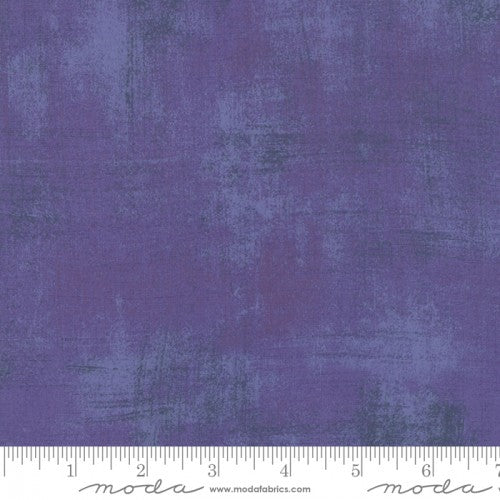 A swatch of textured-effect purple blender quilt fabric.