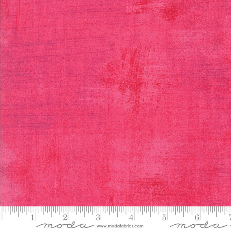 A swatch of bright pink blender quilt fabric with a textured effect.