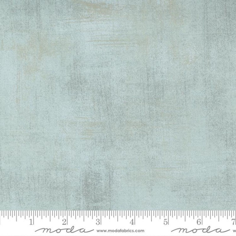A swatch of textured-effect blender quilt fabric in blue and gray tones.