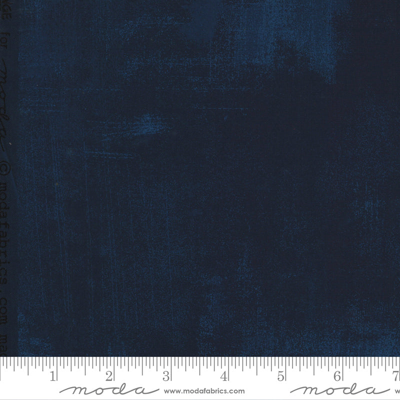 A swatch of solid navy blue fabric with a textured effect.