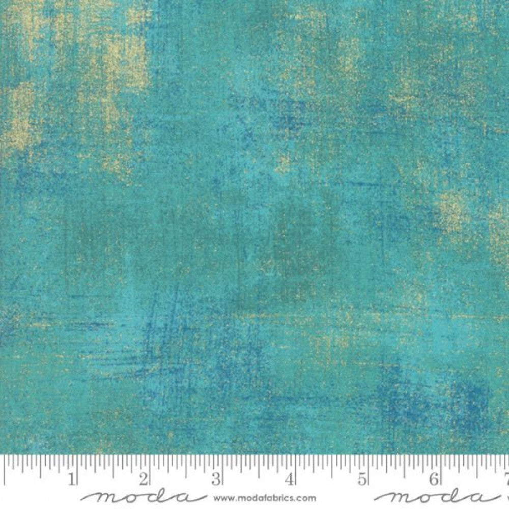 A swatch of textured-effect fabric with metallic peacock blue and gold accents.