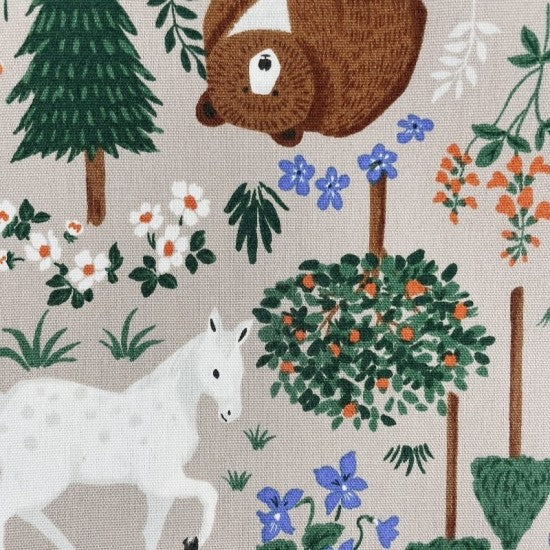 Taupe quilting cotton fabric printed with a forest scene including bears, squirrels, bunnies, horses, owls, ducks, and foxes among plants and flowers.