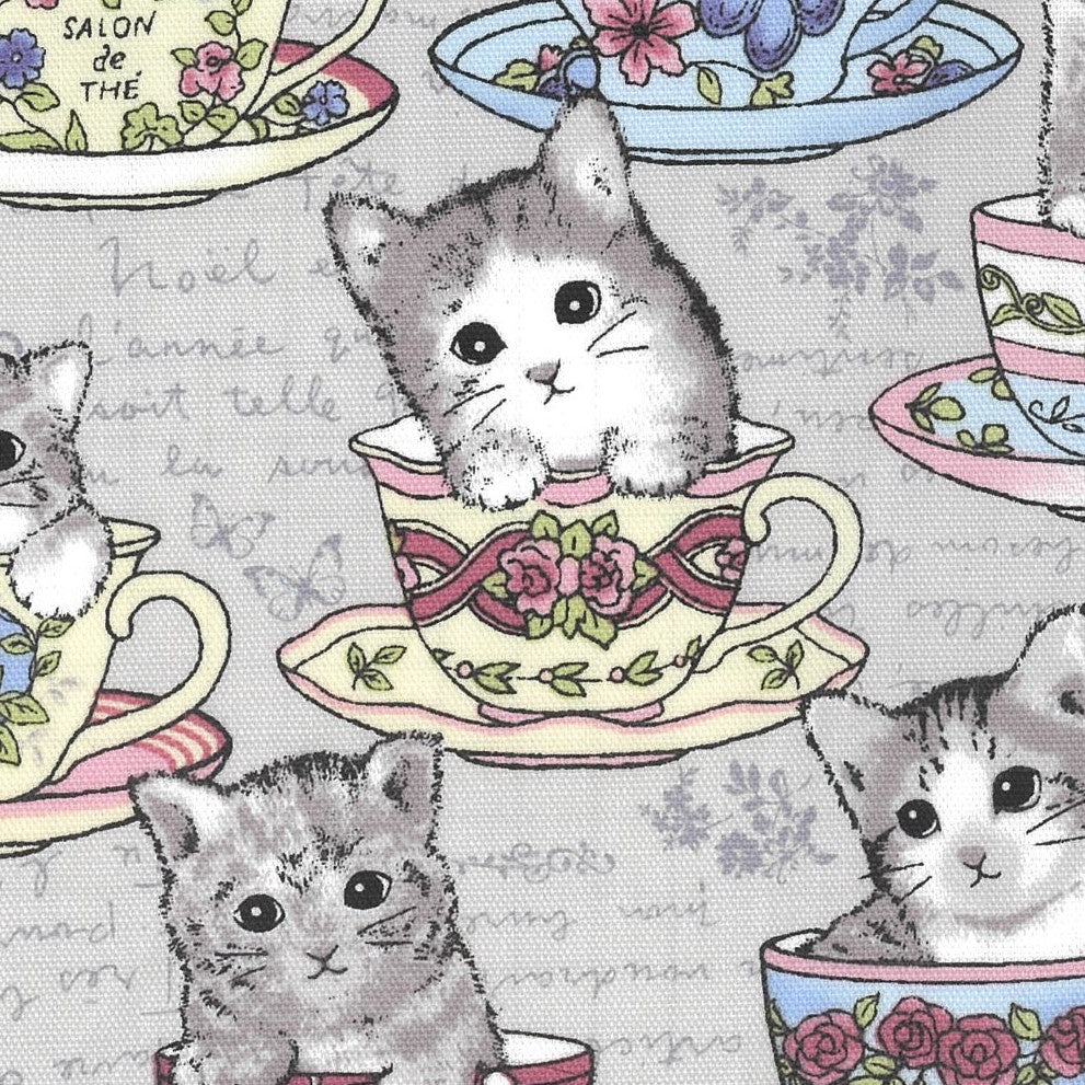 A fabric with a grey background featuring cute kittens inside teacups and cups, along with floral Quilt Fabrics.