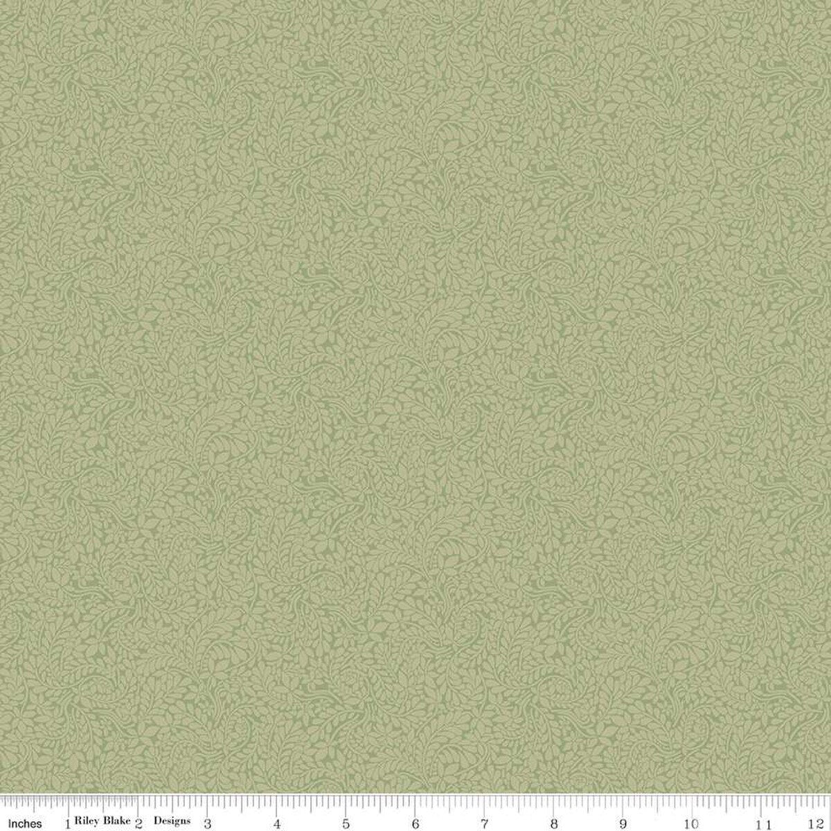 A close-up of a Liberty of London fern green fabric with a small all-over leaf design