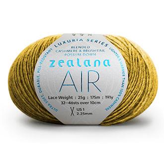 Ball of golden yarn with a 'Zealana Air Lace' label on a white background