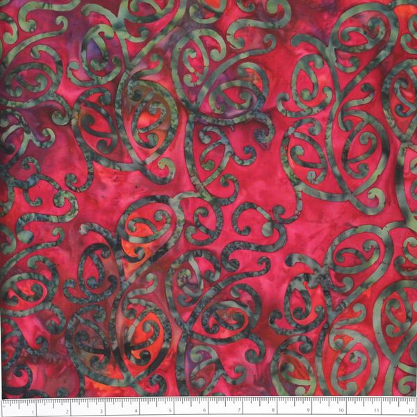 New Zealand designed quilt fabric with Maori style swirls design in green and purple on a raspberry pink background