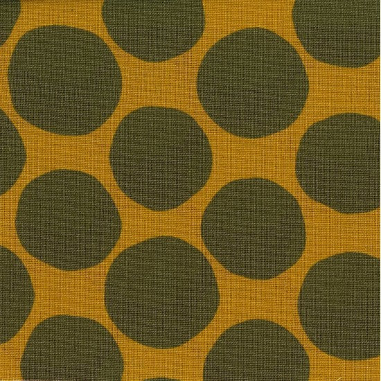 A fabric with a pumpkin orange background featuring olive green circles distributed evenly across the surface.