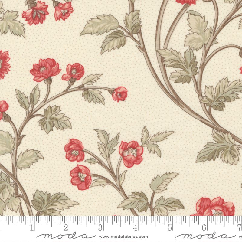 A swatch of fabric with a floral design featuring red flowers and green leaves on a ivory background.