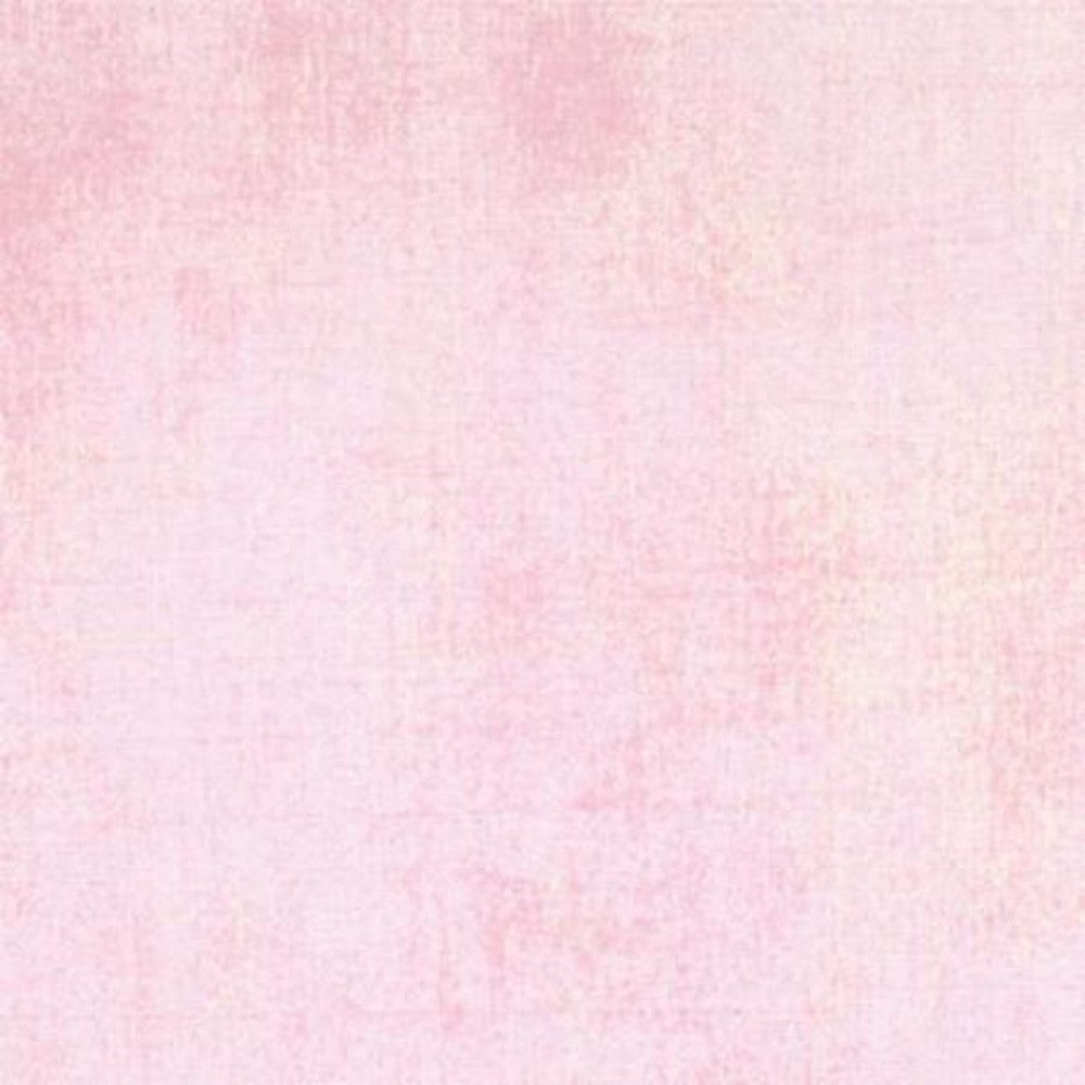 A swatch of pale pink textured-effect blender quilting fabric for quilting and crafts.