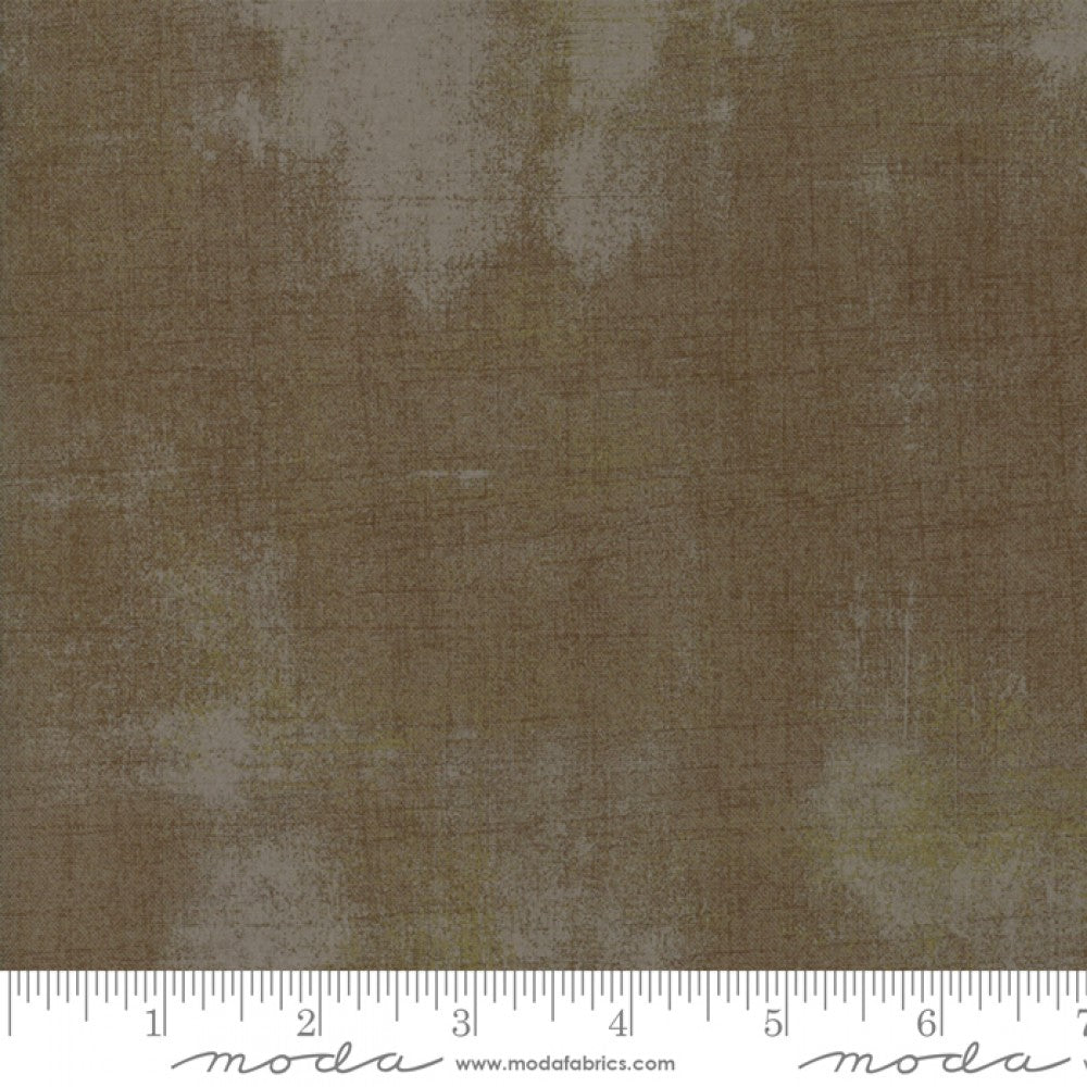 A swatch of textured colored quilting fabric in a brown shade.