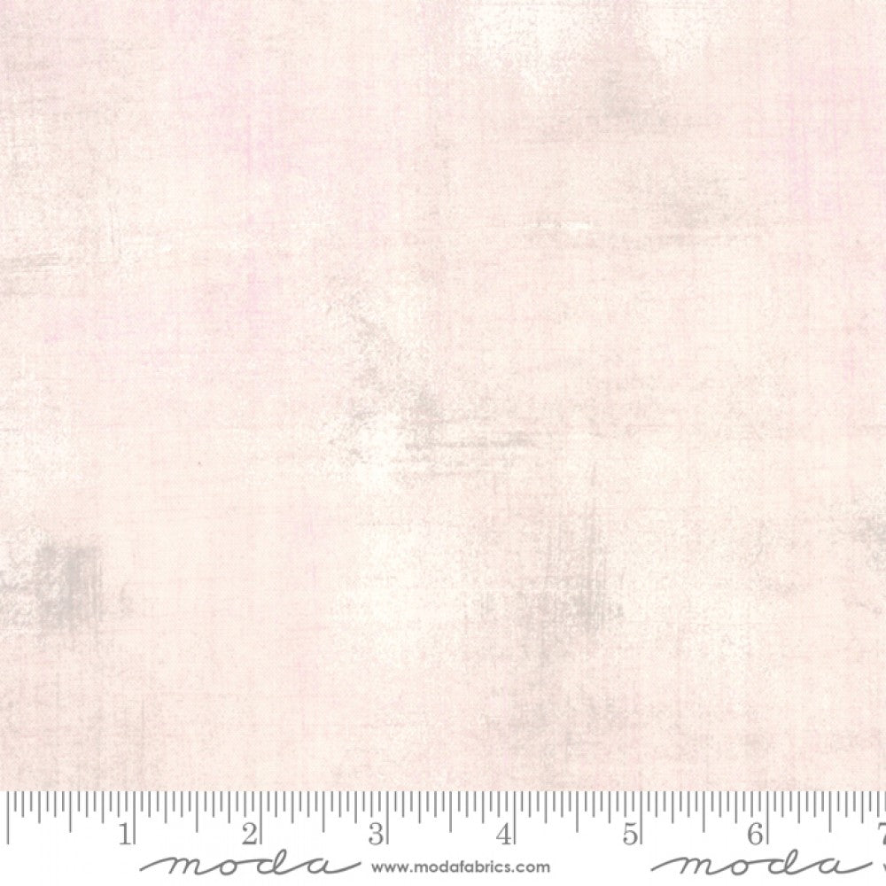 A swatch of textured-effect blender quilting fabric in pink.
