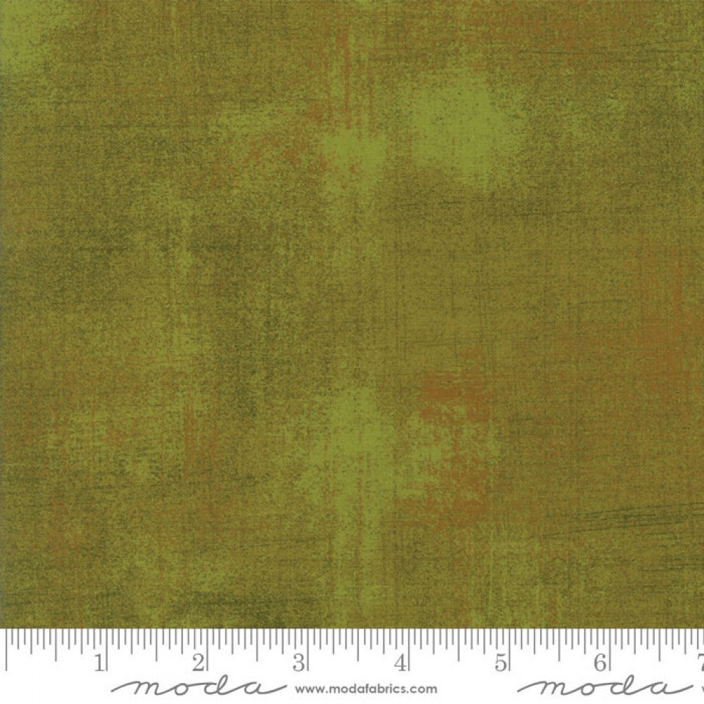 A swatch of textured green fabric with brown accents.