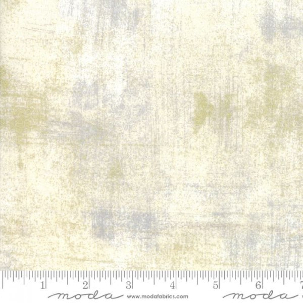 A swatch of quilting fabric with texture effect in metallic colors, displaying a blend of gray, gold, and white hues.