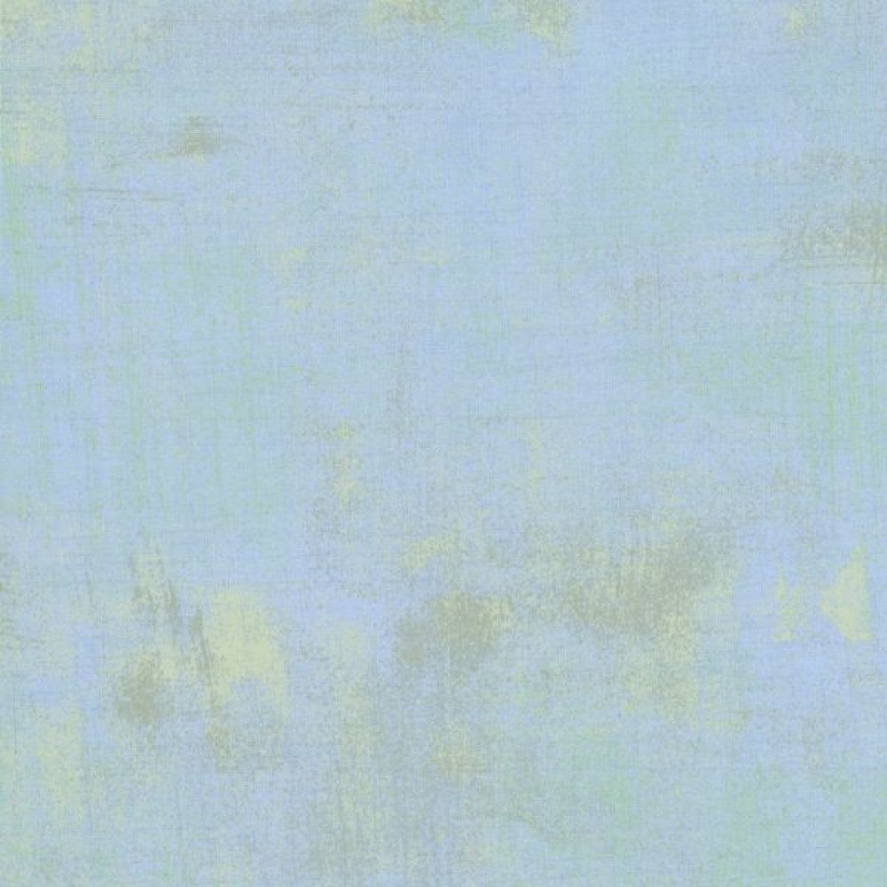 A swatch of pale blue quilting fabric with a textured effect.