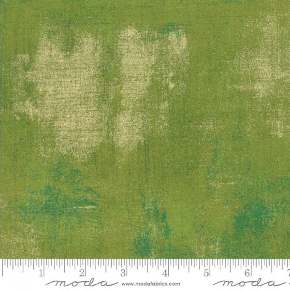 A swatch of quilting fabric with a metallic zesty apple colour.