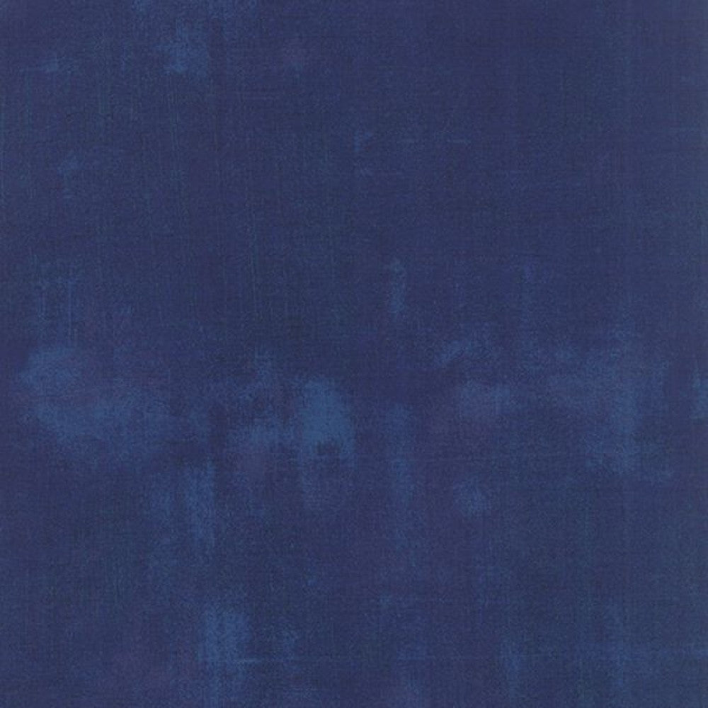 A swatch of solid navy blue quilting fabric with a textured effect.