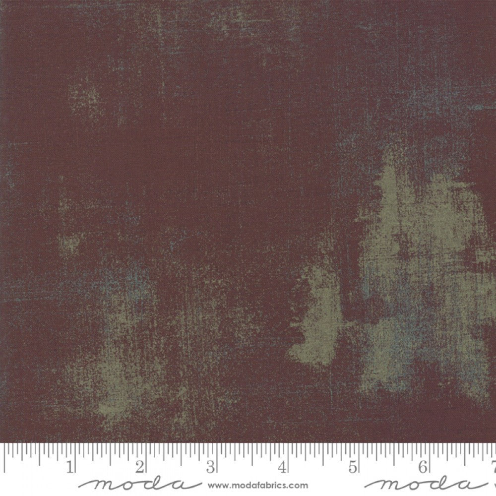 A swatch of textured colored quilting fabric in a brown shade.