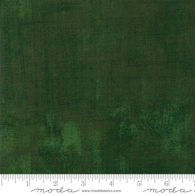 A swatch of Christmas green textured-effect blender quilting fabric.
