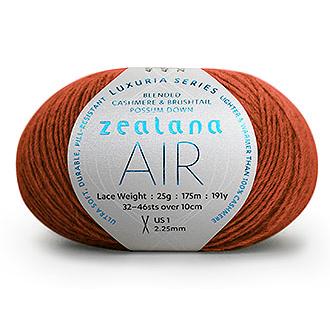 Ball of terracota yarn with a 'Zealana Air Lace' label on a white background