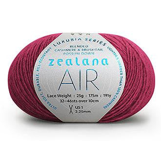 Ball of hot pink yarn with a 'Zealana Air Lace' label on a white background
