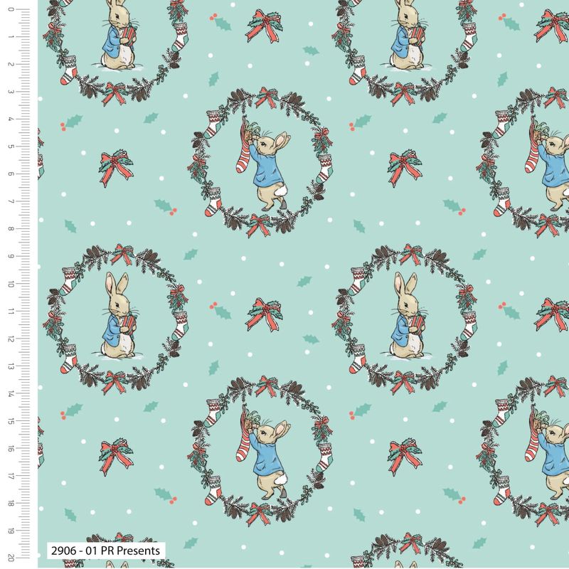 Quilting Fabric featuring an illustration of Peter Rabbit holding a Christmas present, surrounded by holiday-themed elements like wreaths and bows, on a mint green background.