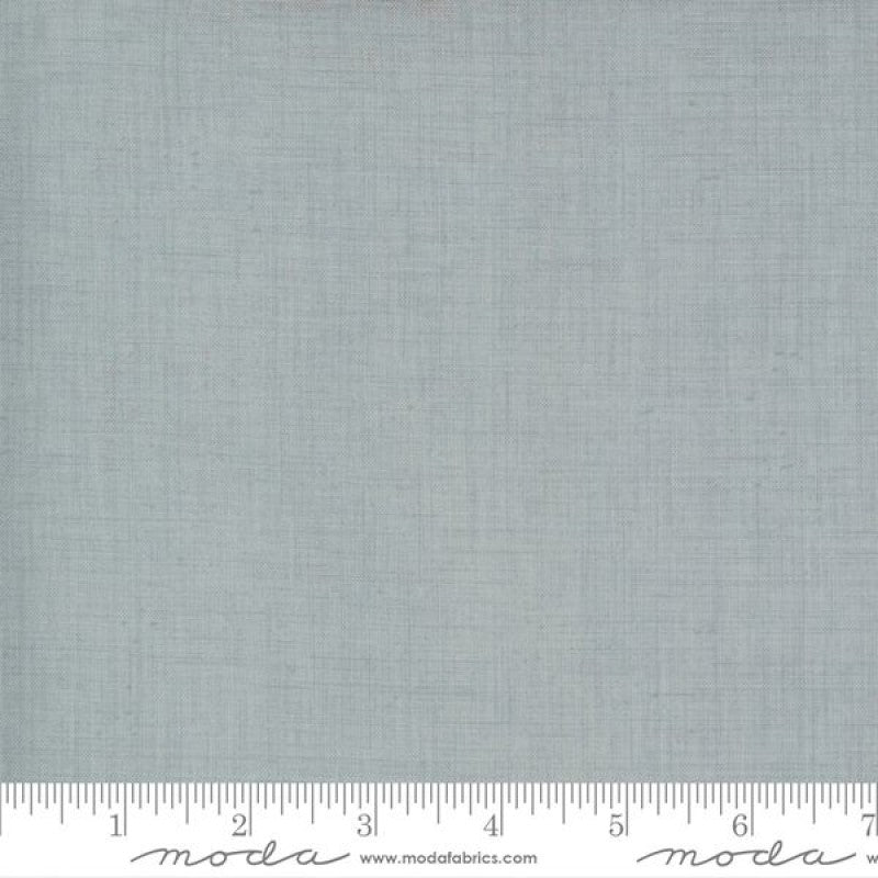 A solid blue quilting fabric from the French General Blender collection, with a visible ruler at the bottom for scale.