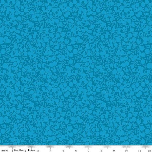 Turquoise Blue fabric pattern with a ruler at the bottom for scale