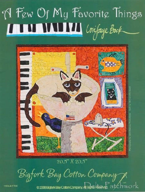 A quilted wall hanging featuring a whimsical design with a cat, keyboard, and other objects, with a red, orange, and white color scheme.