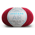 Ball of bright red yarn with a 'Zealana Air Lace' label on a white background