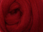 Closeup of New Zealand unspun fibre in colour Cherry Red