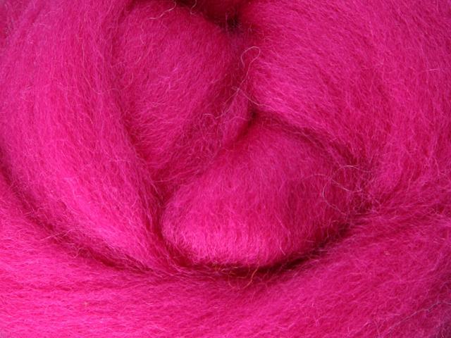 Closeup of New Zealand unspun fibre in colour Magenta
