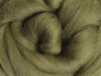 Closeup of New Zealand unspun fibre in colour Olive Green