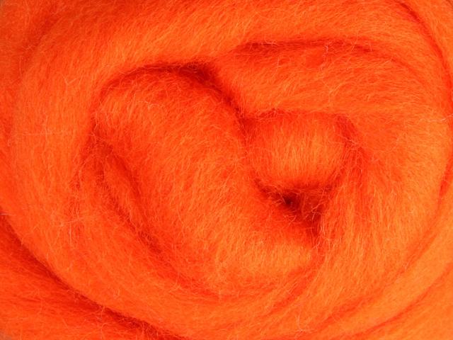 Closeup of New Zealand unspun fibre in colour Orange