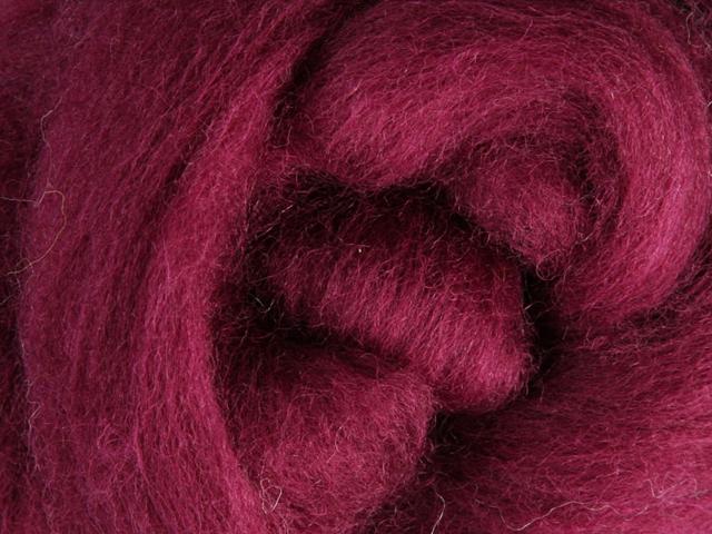 Closeup of New Zealand unspun fibre in colour Raspberry