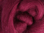 Closeup of New Zealand unspun fibre in colour Raspberry