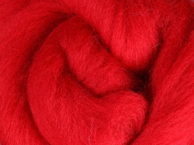 Closeup of New Zealand unspun fibre in colour Scarlet