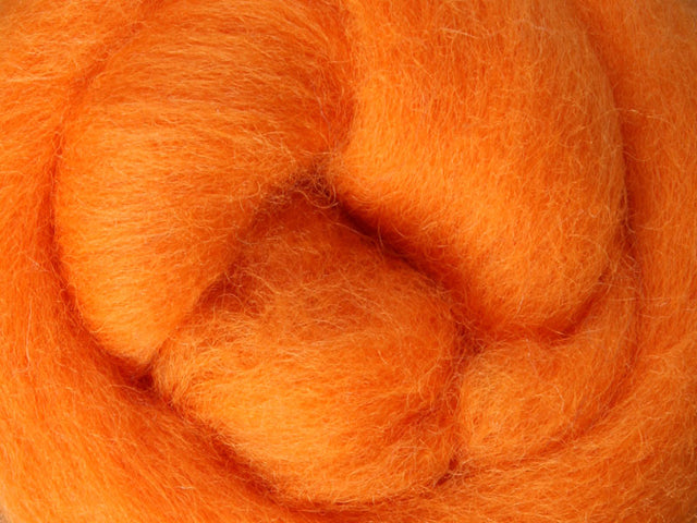 Closeup of New Zealand unspun fibre in colour Tangerine