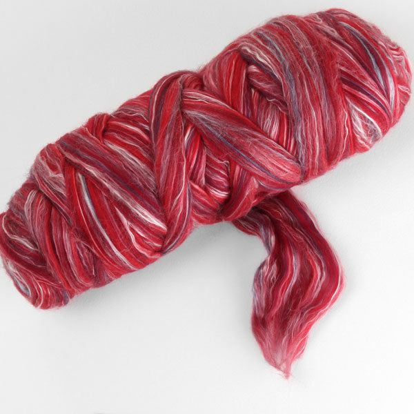 Picture of a batt of New Zealand Merino and Silk unspun fibre dyed in multi-colour berry reds