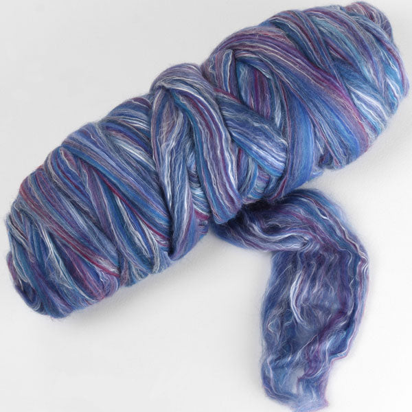 Picture of a batt of New Zealand Merino and Silk unspun fibre dyed in multi-colour blues