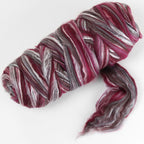 Picture of a batt of New Zealand Merino and Silk unspun fibre dyed in multi-colour storm purples and reds