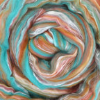 Close up picture of a sample of New Zealand Merino and Silk unspun fibre dyed in multi-colour s of the arizona desert rusts and turquoise