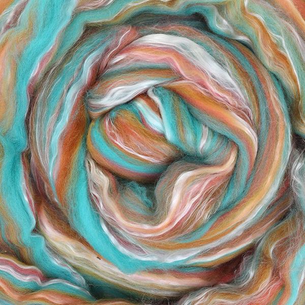 Close up picture of a sample of New Zealand Merino and Silk unspun fibre dyed in multi-colour s of the arizona desert rusts and turquoise