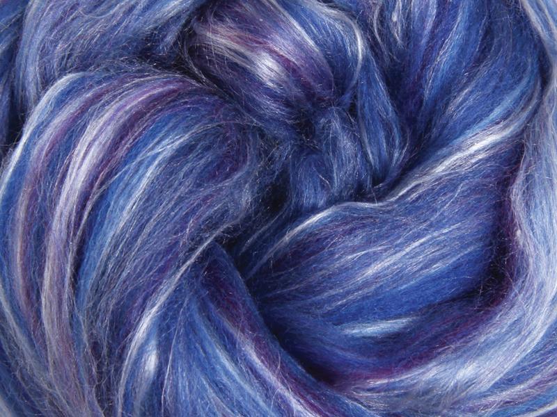Close up picture of a sample of New Zealand Merino and Silk unspun fibre dyed in multi-colour blues