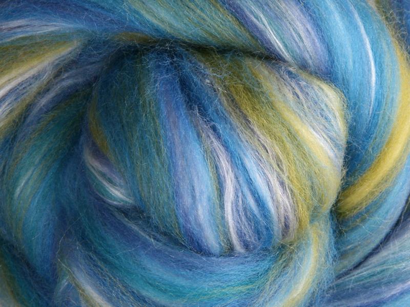 Close up picture of a sample of New Zealand Merino and Silk unspun fibre dyed in multi-colour blues and greens