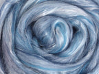 Close up picture of a sample of New Zealand Merino and Silk unspun fibre dyed in multi-colour sky blues