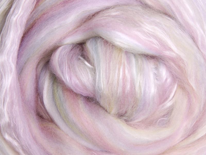 Close up picture of a sample of New Zealand Merino and Silk unspun fibre dyed in multi-colour light sorbet pinks