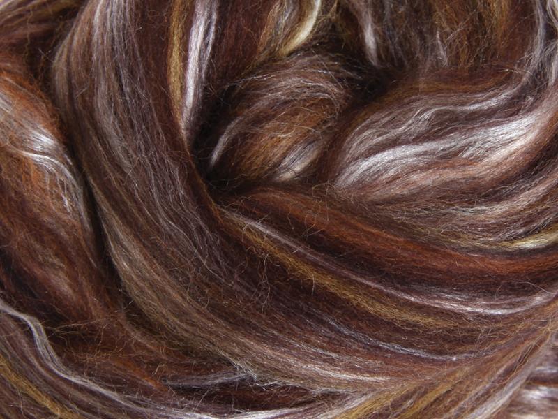 Close up picture of a sample of New Zealand Merino and Silk unspun fibre dyed in multi-colour  spice browns