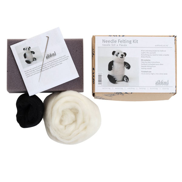 Needle felting kit with wool, needle, foam and instructions on a white background.