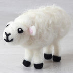 Sample of a needle felted New Zealand Sheep on a white background
