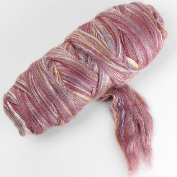 Picture of a batt of New Zealand Merino and Silk unspun fibre dyed in multi-colour mulberry reds